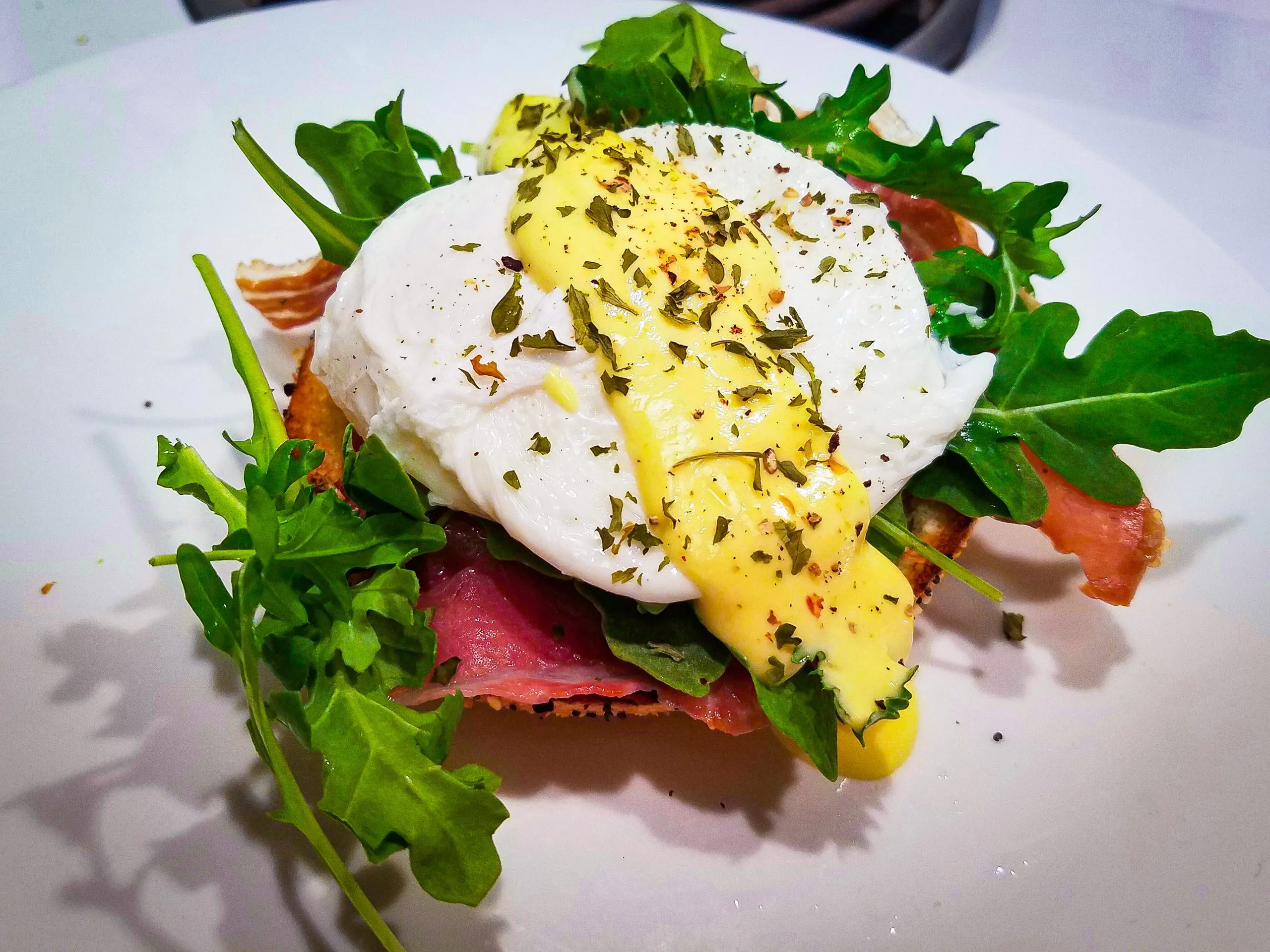 Eggs Benedict over Arugula