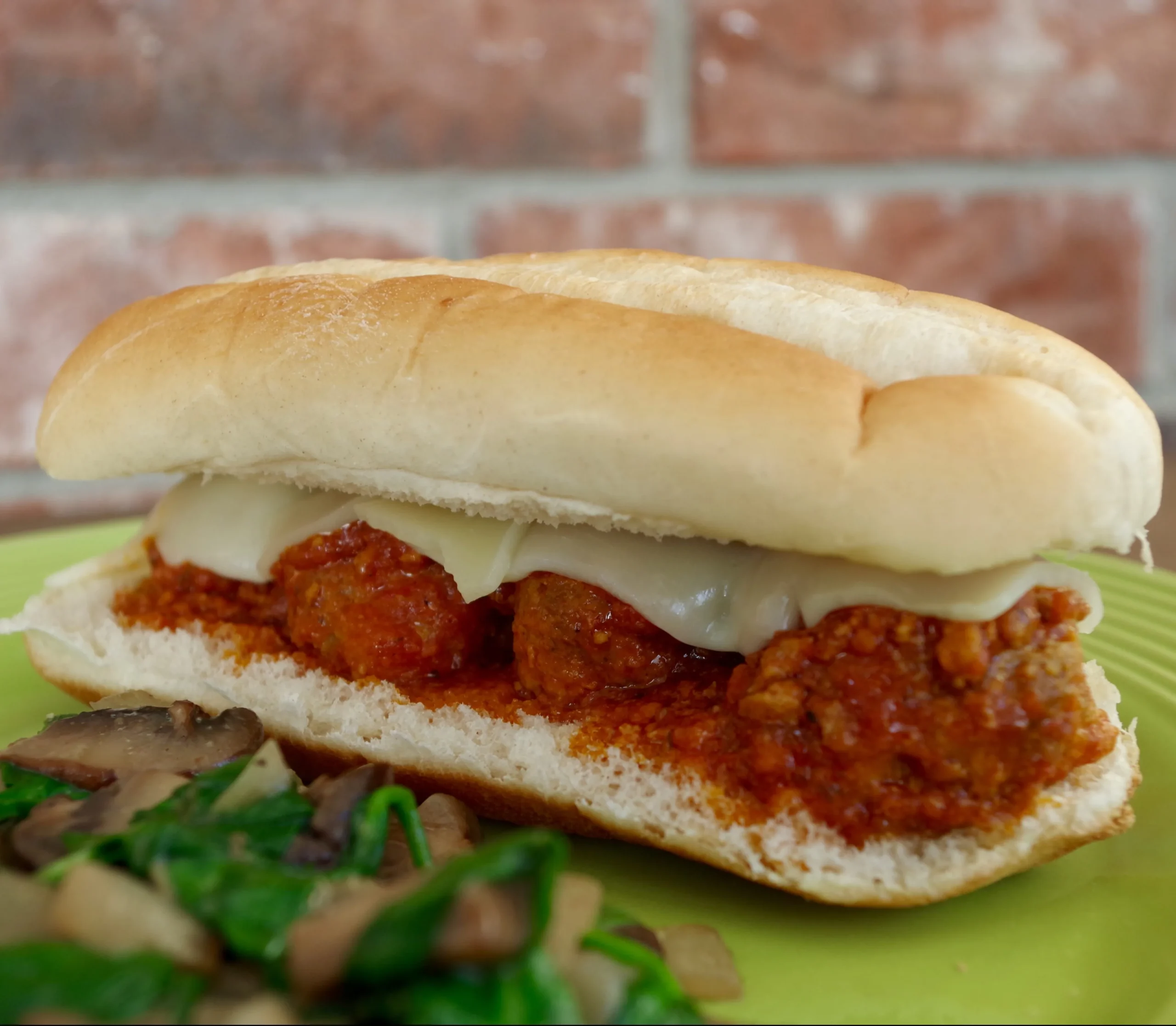 Meatball Sandwiches with Tomato Cream Sauce, Mozzarella, and Pesto