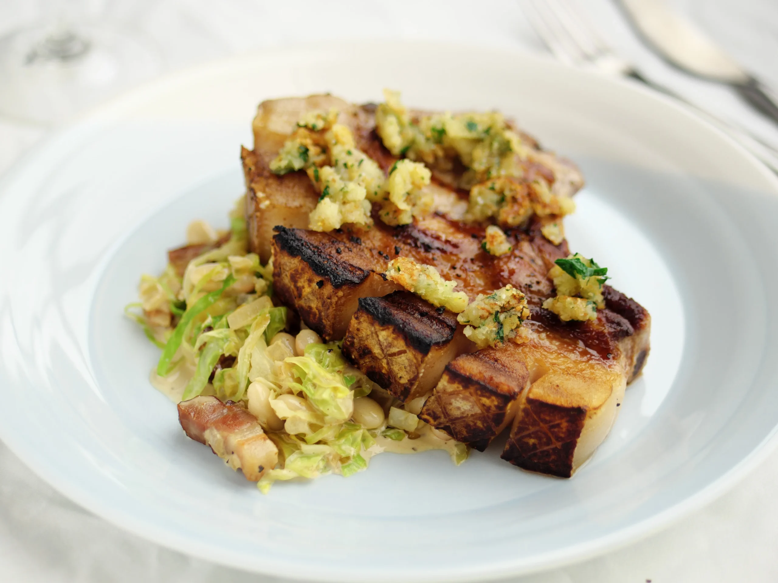 Pepper Rubbed Pork Chops with Warm Bacon and Cabbage Salad